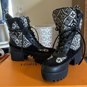 Black and white Louis Vuitton combat boots.